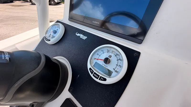 Slide: The Image of The image shows the dashboard of a Mako 214CC boat with a speedometer and screen. - 13