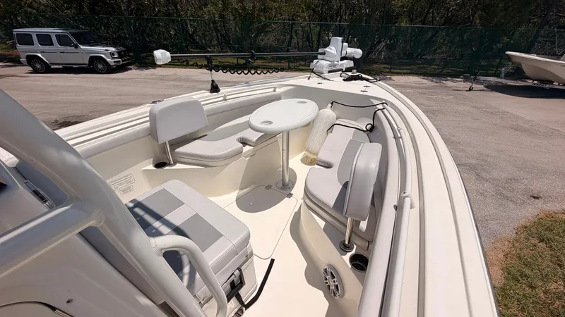 Slide: The Image of The image shows the deck of a 2024 Mako 214CC boat with seating and a table. - 15