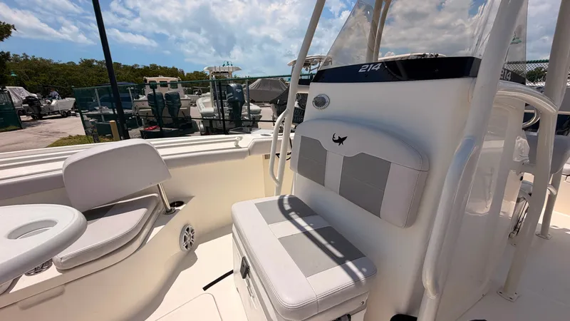 Slide: The Image of The image shows the cockpit of a 2024 Mako 214CC boat with seating and a helm console. - 16