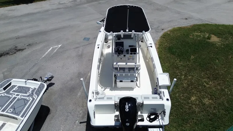 Slide: The Image of Aerial view of a 2024 Mako 214CC boat with a black sunshade and outboard motor. - 20