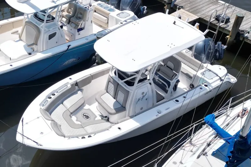 Slide: The Image of 2022 Sea Fox 228 Commander boat docked, featuring spacious seating and modern design. - 8