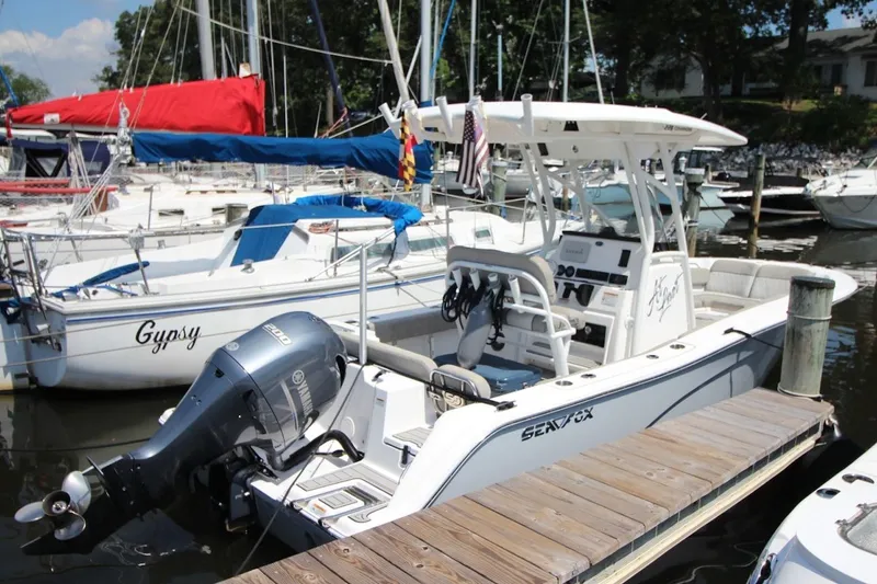 The Image of 2022 Sea Fox 228 Commander boat docked, featuring a powerful outboard motor. - 0