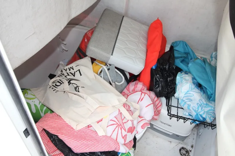 Slide: The Image of Storage compartment of 2022 Sea Fox 228 Commander boat with various items and gear. - 14
