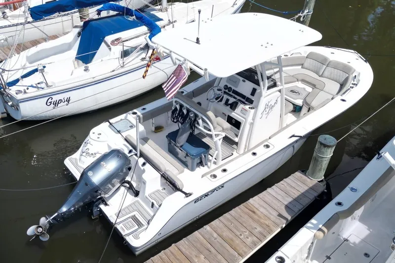 Slide: The Image of 2022 Sea Fox 228 Commander boat docked, featuring a sleek design and powerful outboard motor. - 5