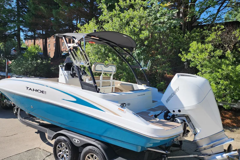 Slide: The Image of 2026 Tahoe 2150 CC boat with Mercury engine on trailer, surrounded by greenery. - 3
