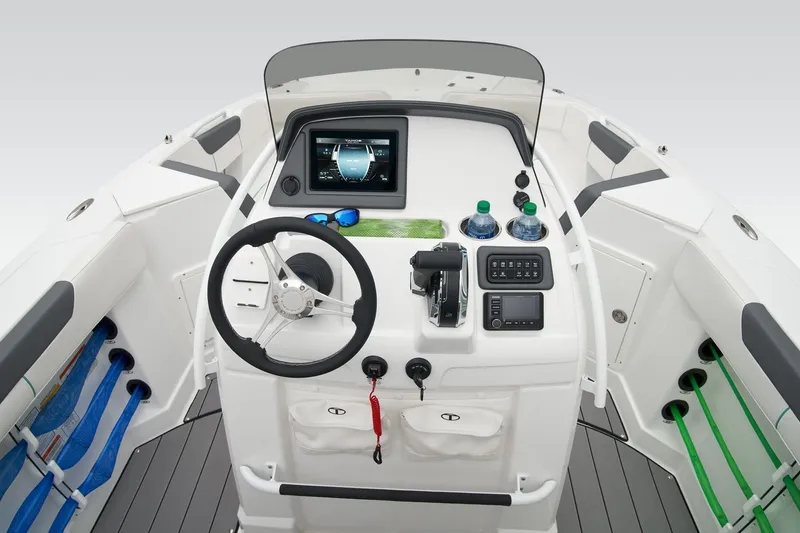 Slide: The Image of 2026 Tahoe 2150 CC boat cockpit with steering wheel, control panel, and navigation display. - 14