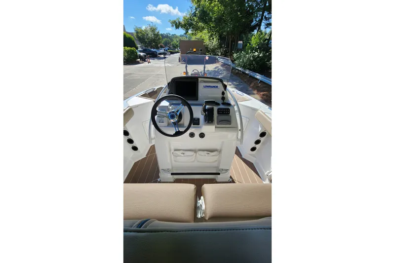 Slide: The Image of 2026 Tahoe 2150 CC boat cockpit with steering wheel and navigation system. - 7