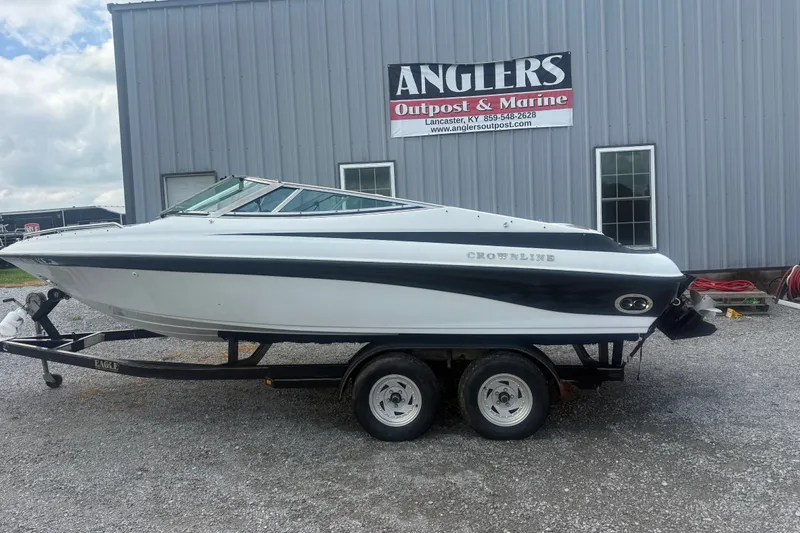 The Image of 2000 Crownline 202 BR boat on trailer at Anglers Outpost & Marine dealership. - 1