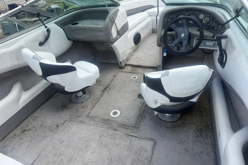 Slide: The Image of Interior of a 2000 Crownline 202 BR boat with dual swivel seats and steering console. - 19