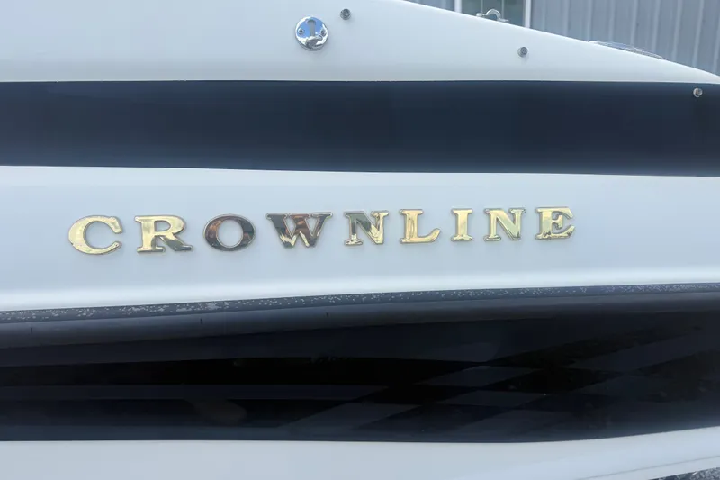 Slide: The Image of Crownline 202 BR 2000 boat logo on white hull. - 5