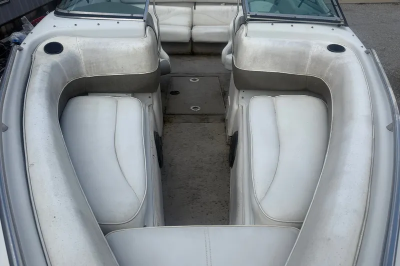 Slide: The Image of Interior view of a 2000 Crownline 202 BR boat with white seating. - 11