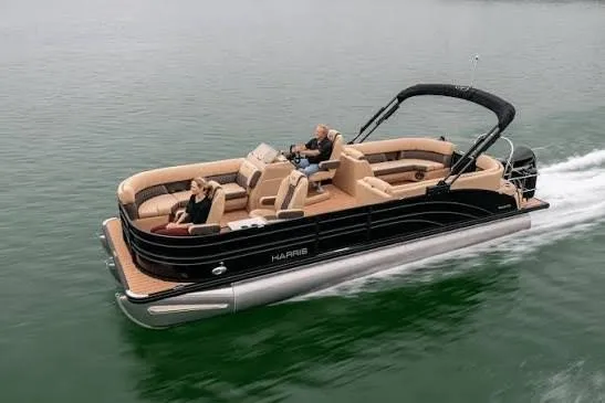 The Image of 2026 Harris 230 Sunliner pontoon boat cruising on calm water. - 0