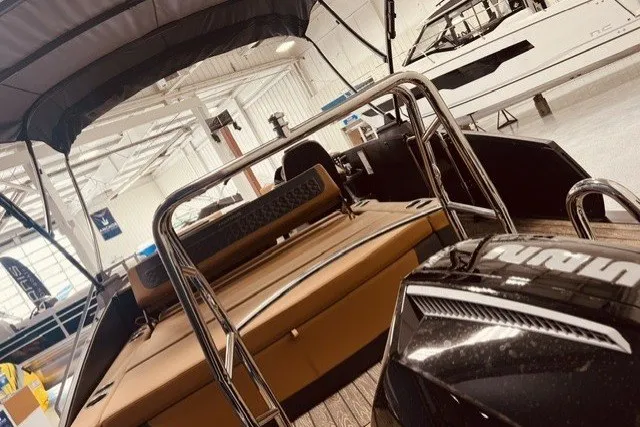 Slide: The Image of 2026 Harris FloteBote 230 Sunliner pontoon boat displayed in a showroom. - 14