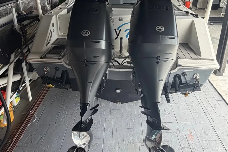 Slide: The Image of 2020 Tidewater 280 CC Adventure boat with dual outboard engines in a garage setting. - 6