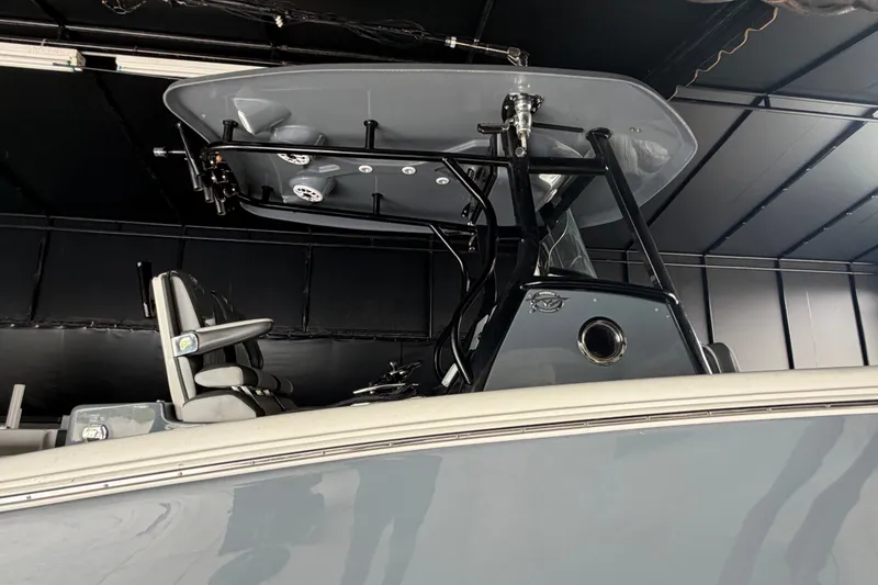 Slide: The Image of 2020 Tidewater 280 CC Adventure boat interior with seating and overhead console. - 19