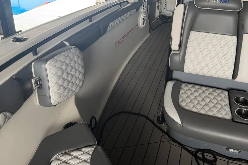 Slide: The Image of 2020 Tidewater 280 CC Adventure boat interior with quilted seats and cup holders. - 16