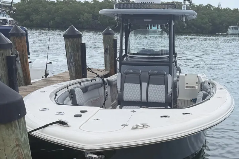 Slide: The Image of 2020 Tidewater 280 CC Adventure boat docked at marina, featuring sleek design and spacious seating. - 20
