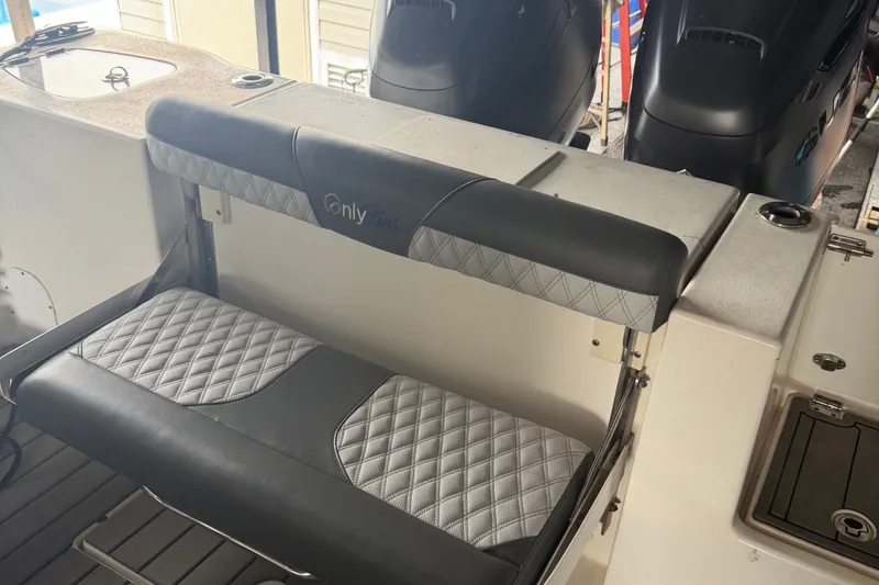Slide: The Image of 2020 Tidewater 280 CC Adventure boat seat with quilted upholstery and dual outboard motors. - 7