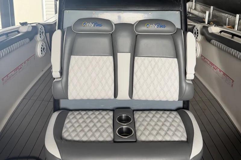 Slide: The Image of 2020 Tidewater 280 CC Adventure boat interior with diamond-stitched seating and cup holders. - 17