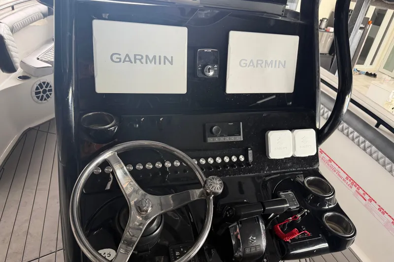 Slide: The Image of 2020 Tidewater 280 CC Adventure boat dashboard with Garmin navigation displays. - 11