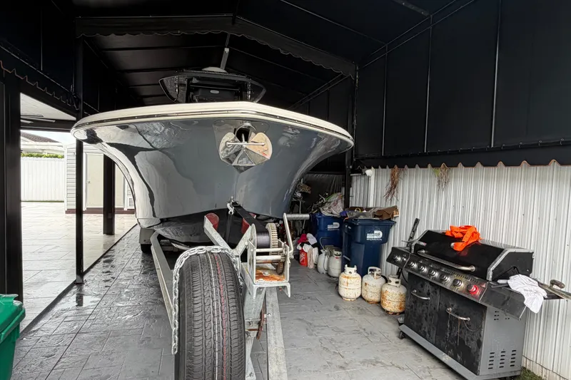 Slide: The Image of 2020 Tidewater 280 CC Adventure boat on trailer in covered storage area. - 18