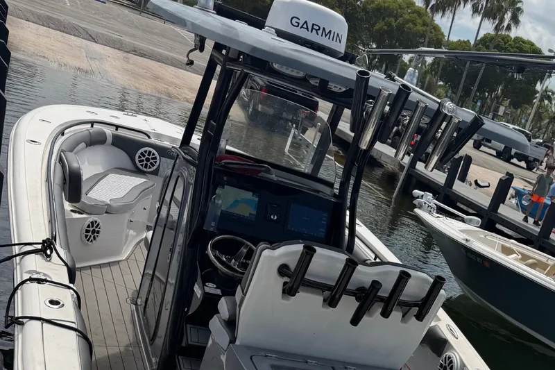 Slide: The Image of 2020 Tidewater 280 CC Adventure boat with Garmin navigation, docked at a marina. - 22