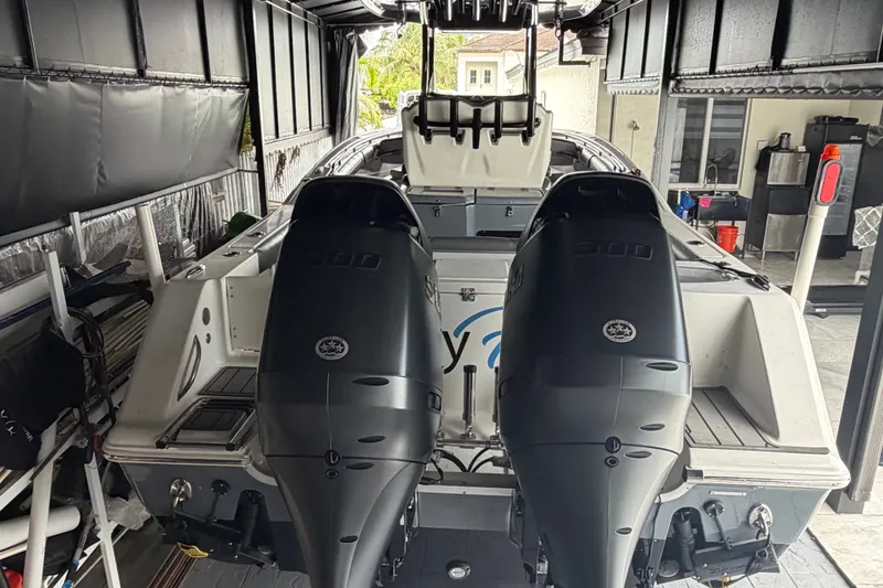 Slide: The Image of 2020 Tidewater 280 CC Adventure boat with dual 300 horsepower engines in a covered storage area. - 4