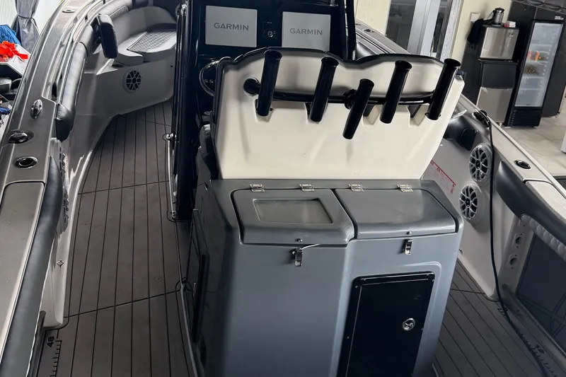 Slide: The Image of 2020 Tidewater 280 CC Adventure boat interior with Garmin electronics and rod holders. - 9