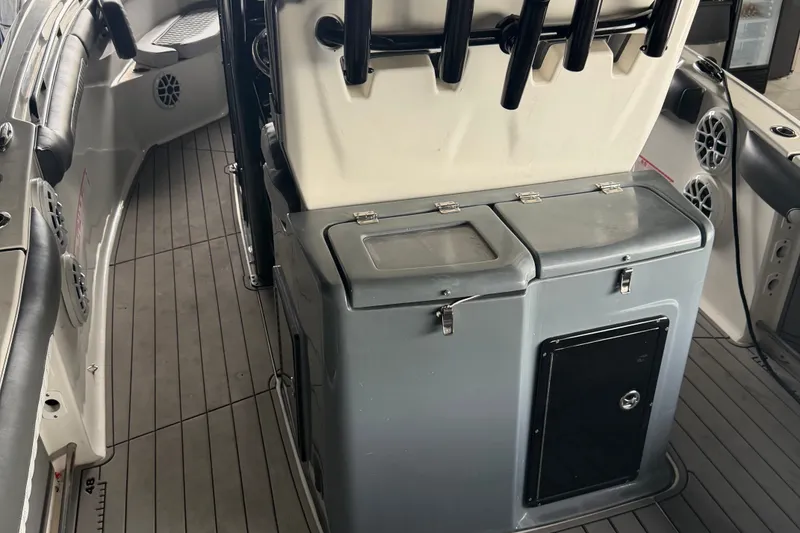 Slide: The Image of 2020 Tidewater 280 CC Adventure boat interior with storage compartments and rod holders. - 8