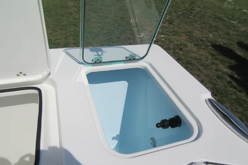 Slide: The Image of Livewell compartment on a 2027 Parker 247 Explorer boat, open lid, outdoor setting. - 8