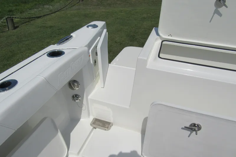 Slide: The Image of 2027 Parker 247 Explorer boat interior, featuring sleek white seating and storage compartments. - 24