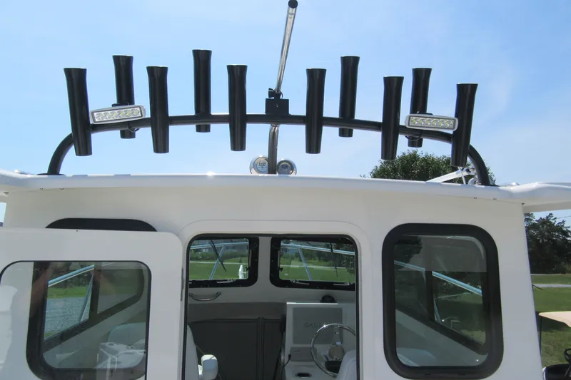 Slide: The Image of 2027 Parker 247 Explorer boat with rod holders and LED lights on the roof. - 23