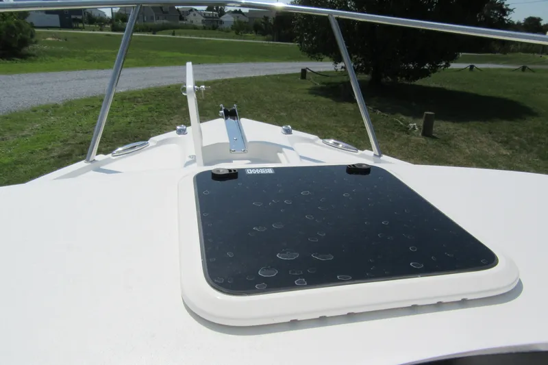 Slide: The Image of Parker 247 Explorer 2027 boat deck with hatch and railing, outdoors. - 22
