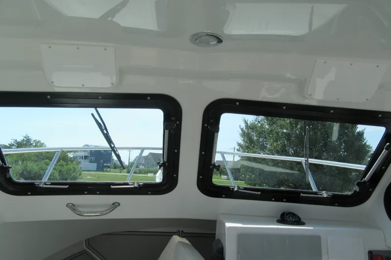 Slide: The Image of Interior view of 2027 Parker 247 Explorer boat with windows and outdoor scenery. - 13