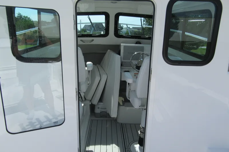 Slide: The Image of Interior view of 2027 Parker 247 Explorer boat, showcasing helm and seating area. - 10