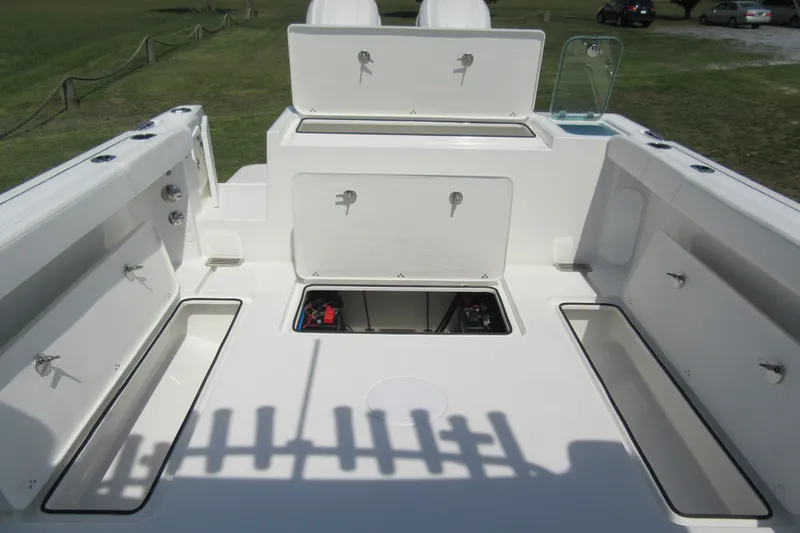 Slide: The Image of 2027 Parker 247 Explorer boat deck with open storage compartments and seating. - 6