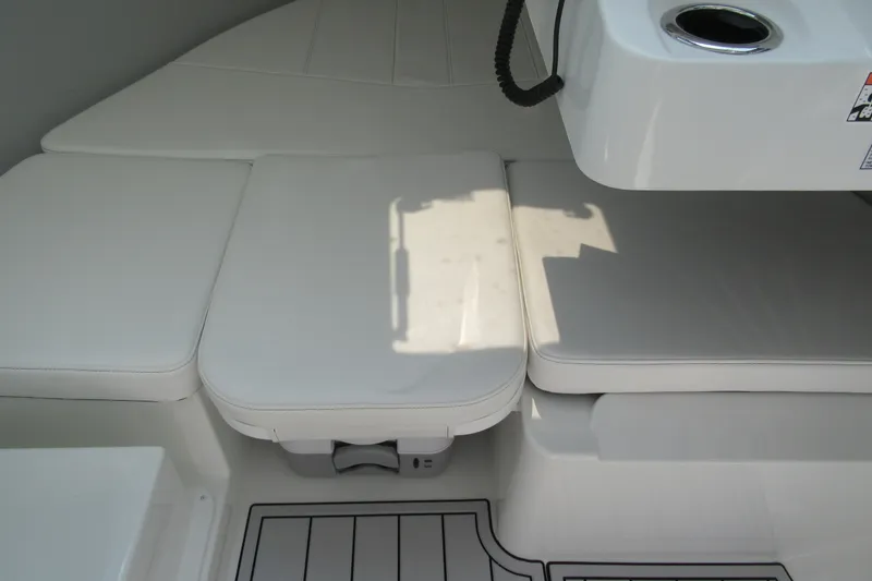 Slide: The Image of Interior seating of 2027 Parker 247 Explorer boat with white cushions and cup holder. - 21