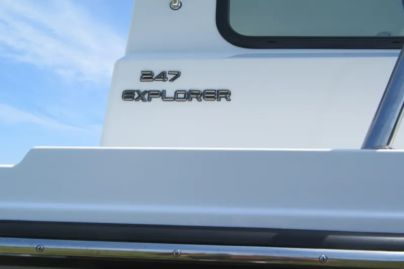 Slide: The Image of Parker 247 Explorer 2027 boat, sleek design with chrome lettering against a clear sky. - 2