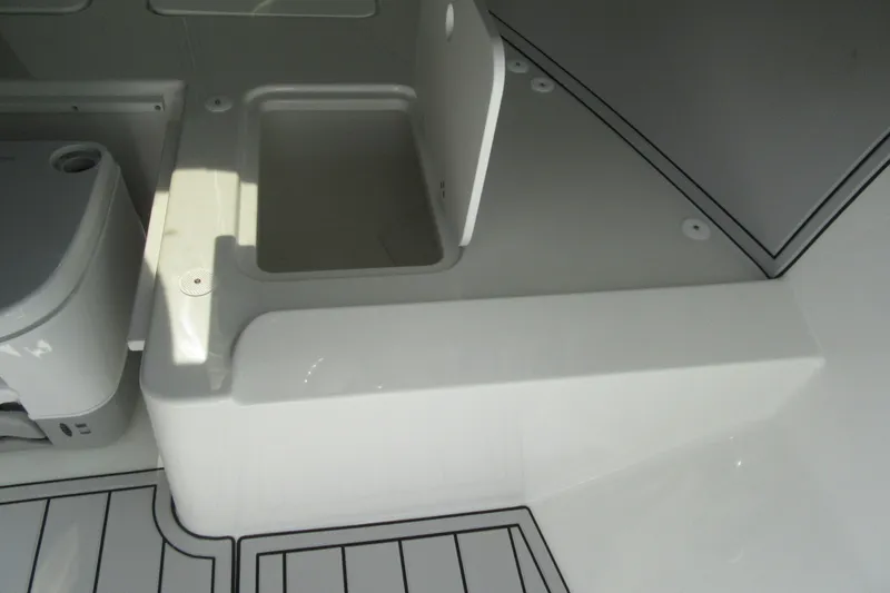 Slide: The Image of Interior view of 2027 Parker 247 Explorer boat, featuring storage compartment and seating area. - 16