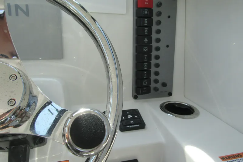 Slide: The Image of Steering wheel and control panel of 2027 Parker 247 Explorer boat cockpit. - 17