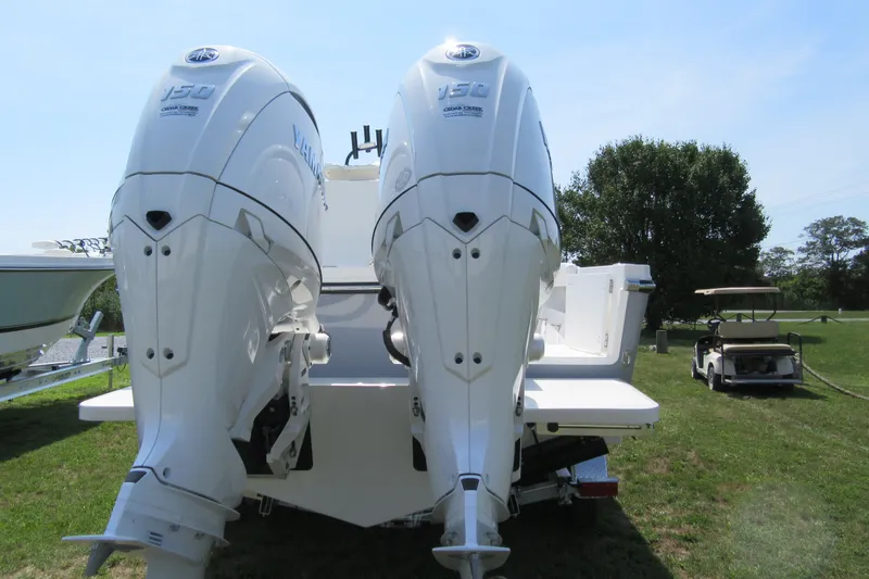 Slide: The Image of Twin Yamaha outboard engines on a 2027 Parker 247 Explorer boat, parked on grass. - 27