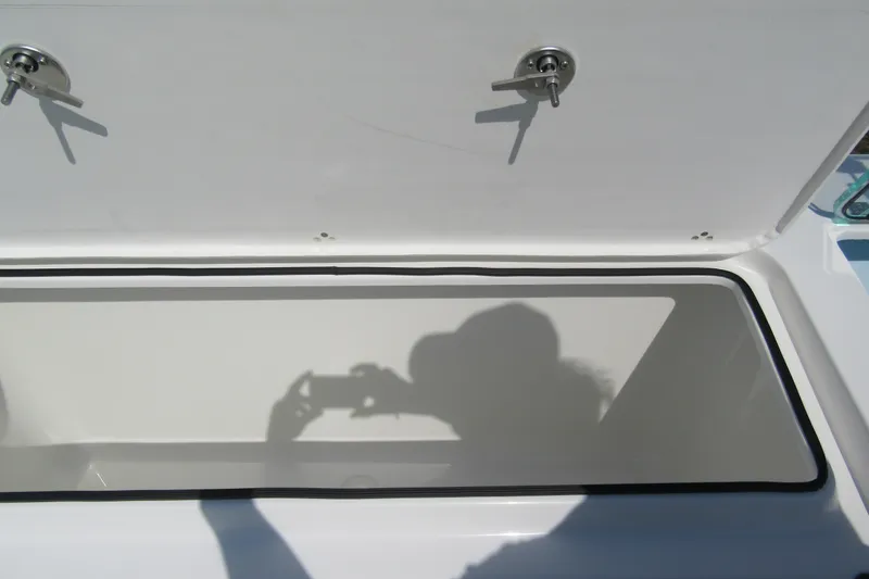 Slide: The Image of Open storage compartment on Parker 247 Explorer boat, 2027 model, with shadow reflection. - 9