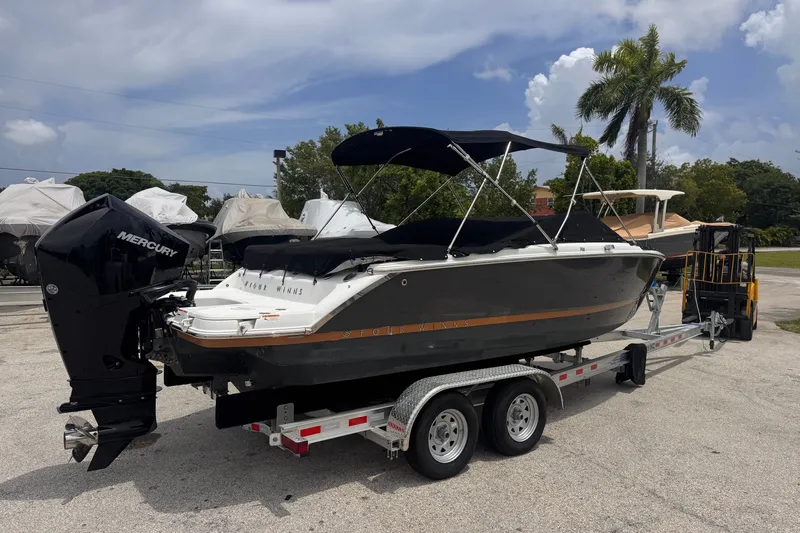 Slide: The Image of 2023 Four Winns H2 OB boat on trailer with Mercury outboard motor. - 6