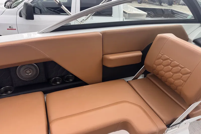 Slide: The Image of 2023 Four Winns H2 OB boat interior with tan leather seating and cup holders. - 11
