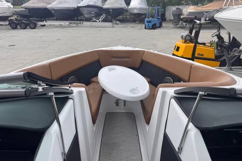 Slide: The Image of 2023 Four Winns H2 OB boat interior with tan seating and white table. - 14