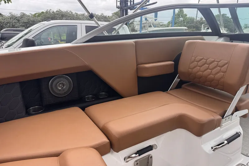 Slide: The Image of 2023 Four Winns H2 OB boat interior with tan leather seating and modern design elements. - 12