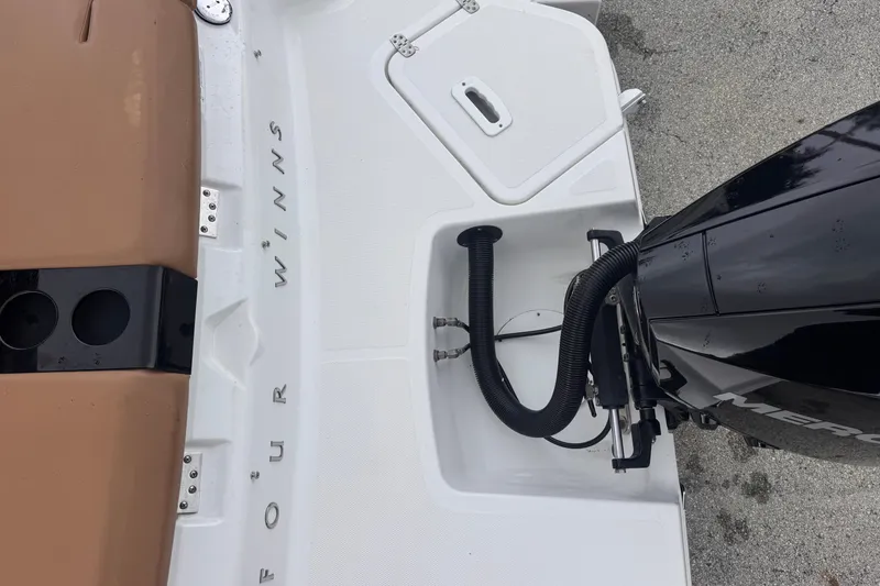 Slide: The Image of 2023 Four Winns H2 OB boat with outboard motor and seating area. - 16
