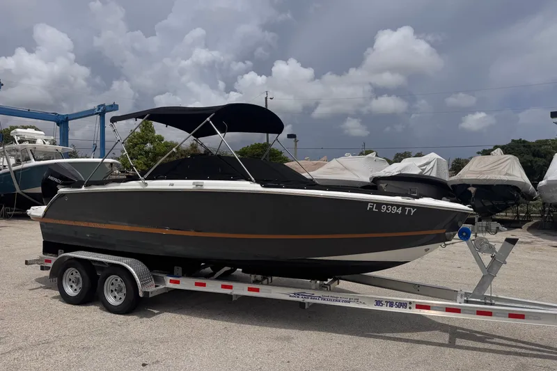 Slide: The Image of 2023 Four Winns H2 OB boat on trailer under cloudy sky. - 7