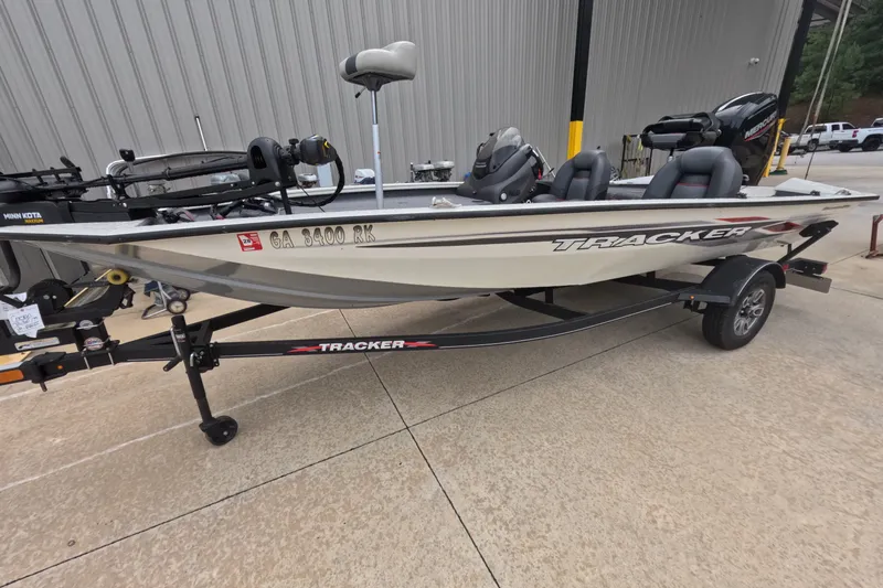 The Image of 2022 Bass Tracker Pro 17 fishing boat on trailer, parked outside a building. - 1
