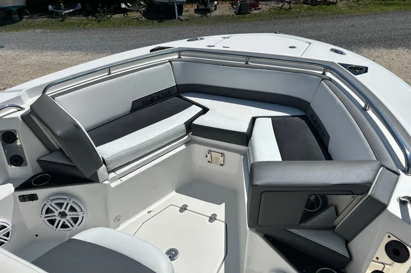 Slide: The Image of 2020 Blackfin 242 CC boat interior with cushioned seating and stainless steel railings. - 14